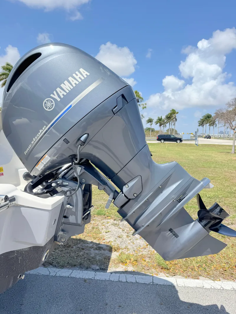 Slide: The Image of 2022 Key West 219 FS boat with Yamaha outboard motor, parked outdoors. - 29