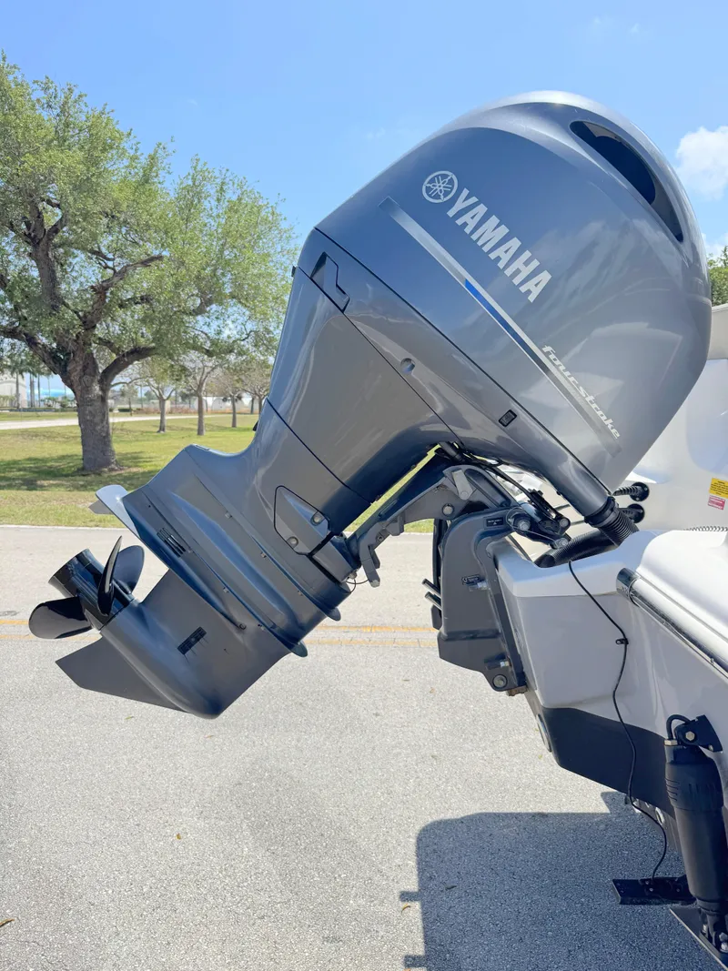 Slide: The Image of 2022 Key West 219 FS boat with Yamaha outboard motor in a sunny outdoor setting. - 30