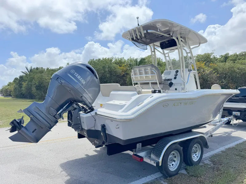 Slide: The Image of 2022 Key West 219 FS boat on trailer with Yamaha outboard motor, parked outdoors. - 4