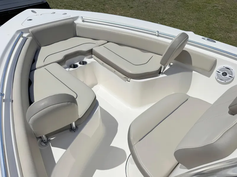Slide: The Image of 2022 Key West 219 FS boat interior with beige cushioned seating and cup holders. - 8