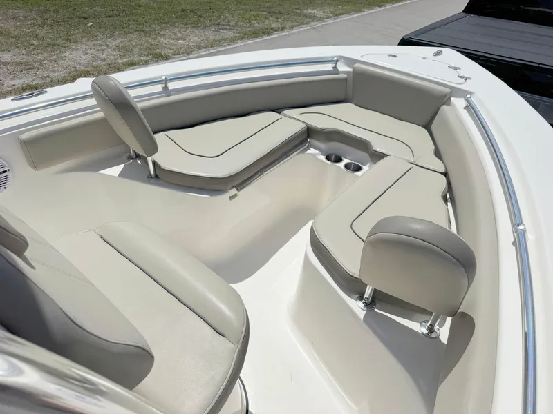 Slide: The Image of 2022 Key West 219 FS boat interior with beige seating and cup holders. - 9