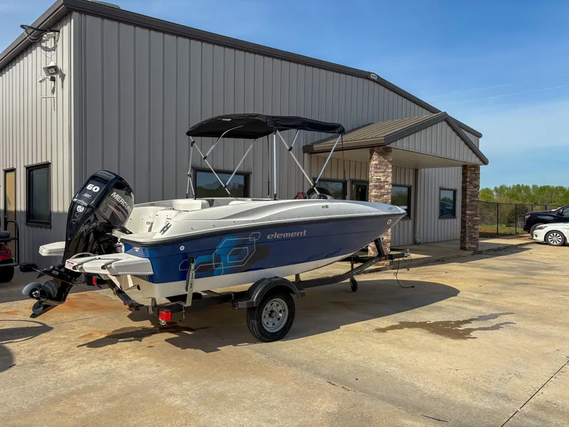 Slide: The Image of 2019 Bayliner Element E16 boat on trailer outside a building, sunny day. - 1
