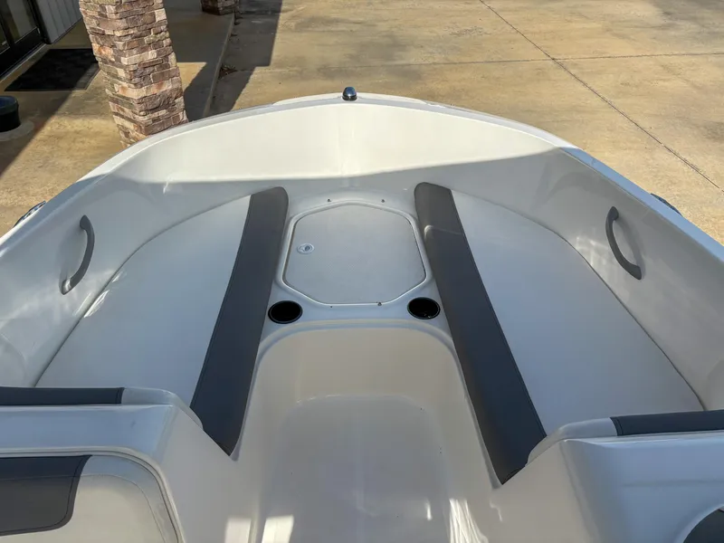 Slide: The Image of 2019 Bayliner Element E16 boat interior with gray seating and cup holders. - 10