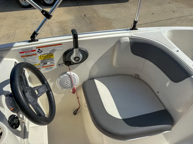 Slide: The Image of 2019 Bayliner Element E16 boat cockpit with steering wheel and seating. - 13