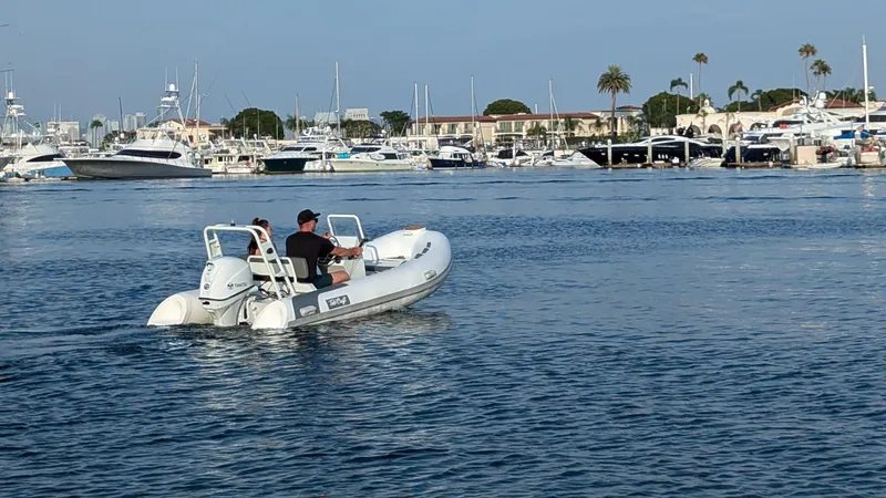 Slide: The Image of Tide Craft Catalina 13 DEMO Boat cruising in a marina, 2025 model. - 6