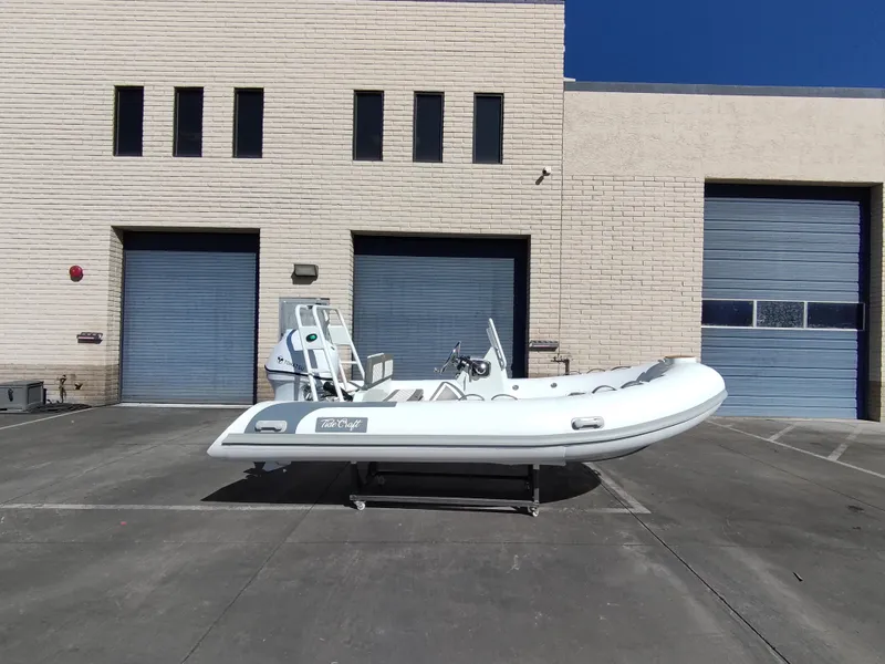 Slide: The Image of 2025 Tide Craft Catalina 13 DEMO Boat displayed outside industrial building. - 8