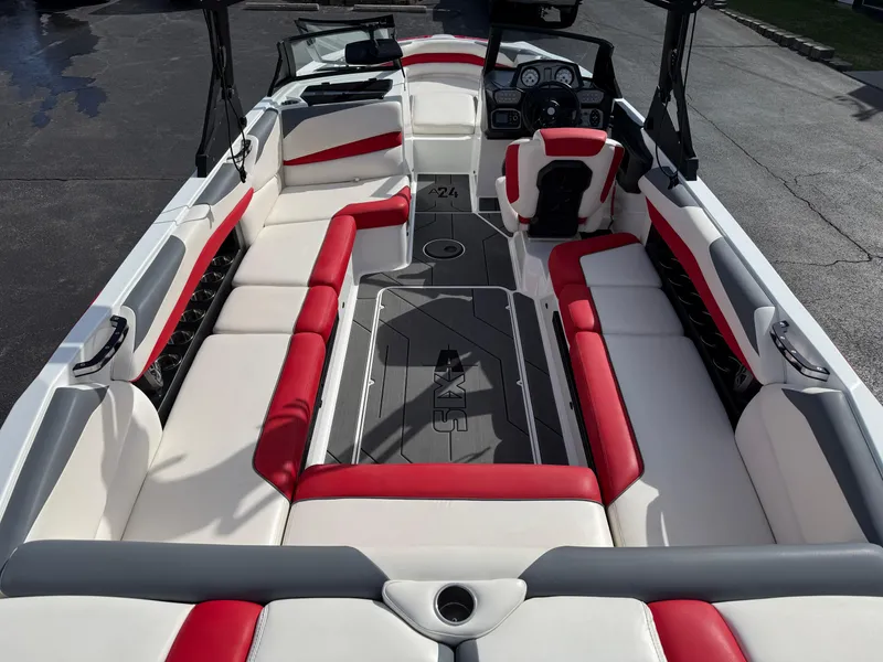 Slide: The Image of 2020 Axis A24 boat interior with red and white seating, sleek design, and modern dashboard. - 11