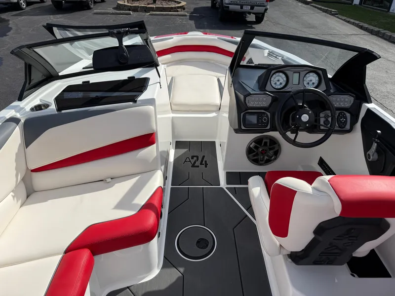 Slide: The Image of 2020 Axis A24 boat interior with red and white seating, modern dashboard, and steering wheel. - 13