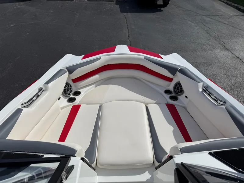 Slide: The Image of 2020 Axis A24 boat interior with red and white seating, cup holders, and speakers. - 14