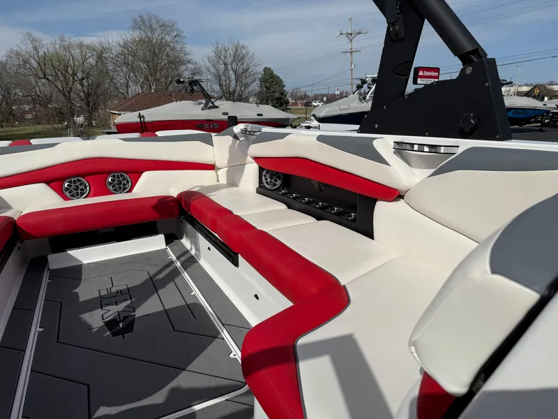 Slide: The Image of 2020 Axis A24 boat interior with red and white seating, featuring modern design and speakers. - 20