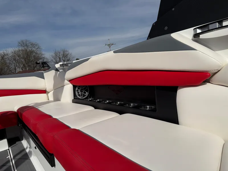 Slide: The Image of 2020 Axis A24 boat interior with red and white seating, cup holders, and speaker. - 21