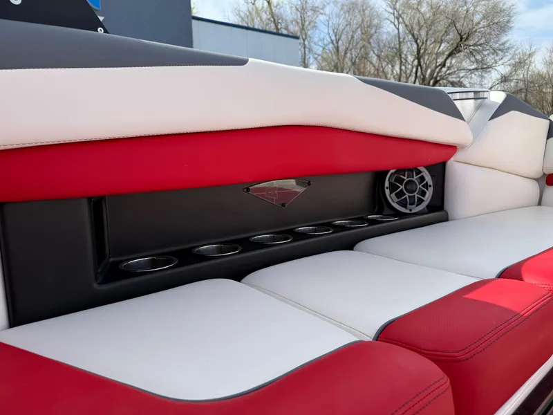 Slide: The Image of 2020 Axis A24 boat interior with red and white seating, cup holders, and speaker. - 23