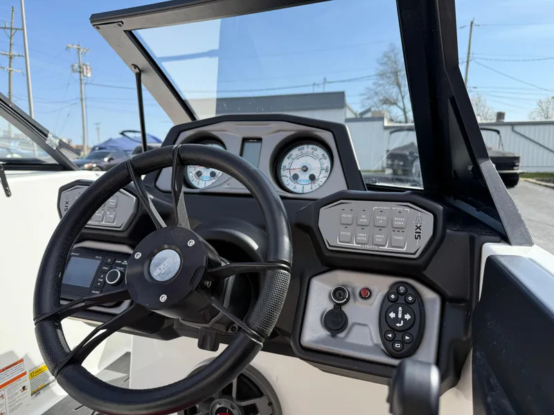Slide: The Image of 2020 Axis A24 boat dashboard with steering wheel and control panel. - 26