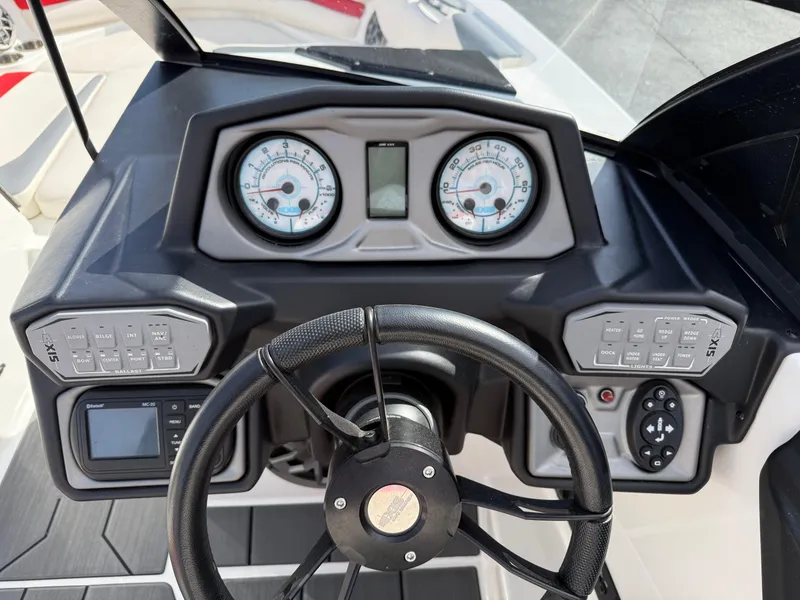 Slide: The Image of 2020 Axis A24 boat dashboard with steering wheel, gauges, and control panels. - 28