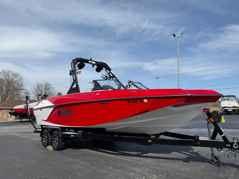 Slide: The Image of 2020 Axis A24 boat in vibrant red on a trailer, parked outdoors. - 4