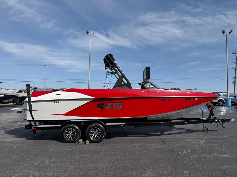 Slide: The Image of Red and white 2020 Axis A24 boat on trailer under clear sky. - 5