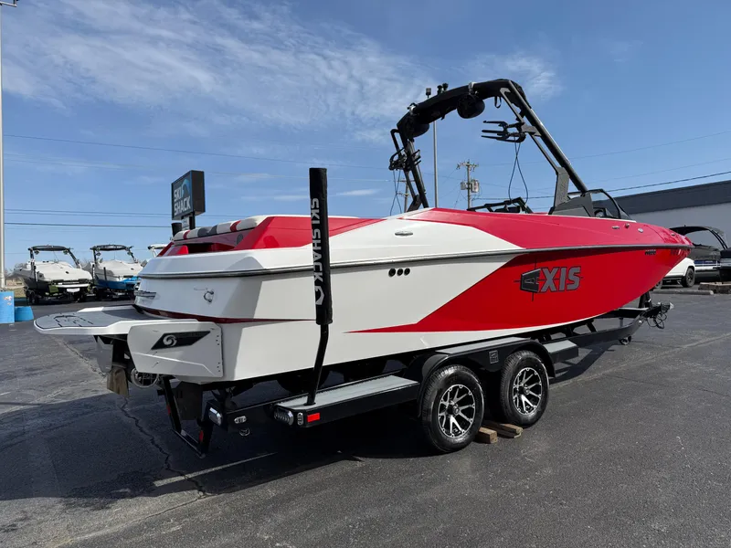 Slide: The Image of 2020 Axis A24 boat with red and white design on a trailer. - 6