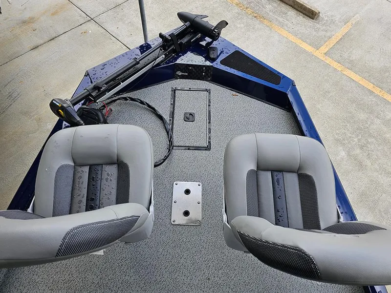 Slide: The Image of 2025 G3 Sportsman 1810 PFX boat interior with two seats and fishing equipment. - 14