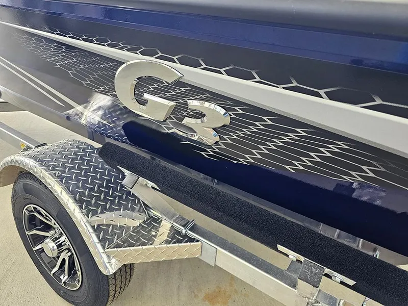 Slide: The Image of 2025 G3 Sportsman 1810 PFX boat with sleek design and trailer. - 19