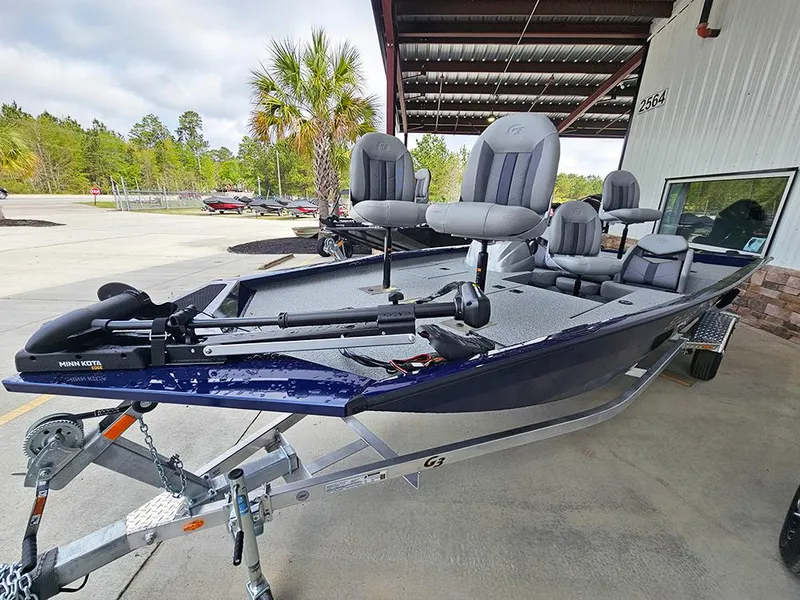 Slide: The Image of 2025 G3 Sportsman 1810 PFX fishing boat on trailer, parked outdoors. - 2