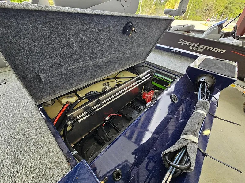 Slide: The Image of 2025 G3 Sportsman 1810 PFX boat storage compartment with fishing gear and equipment. - 6