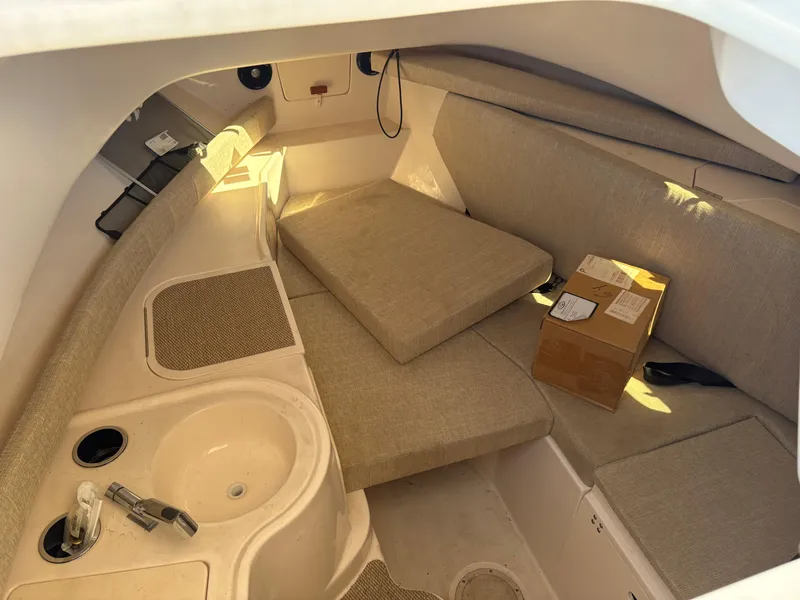 Slide: The Image of 2021 Grady-White 232 Gulfstream cabin interior with seating and sink. - 12