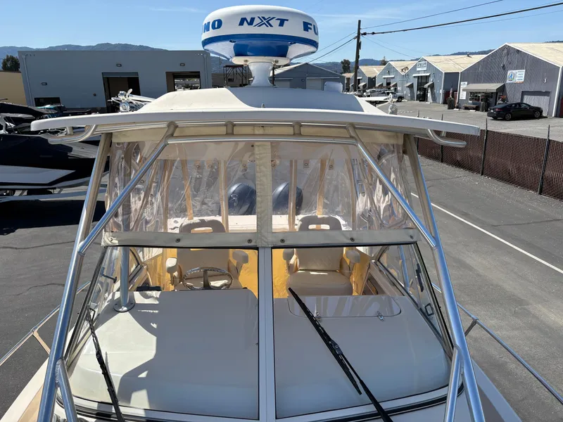 Slide: The Image of 2021 Grady-White 232 Gulfstream boat with radar, docked in a marina. - 14