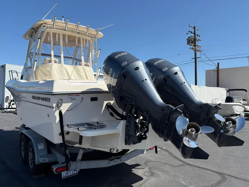 Slide: The Image of 2021 Grady-White 232 Gulfstream boat with dual outboard engines on a trailer. - 3