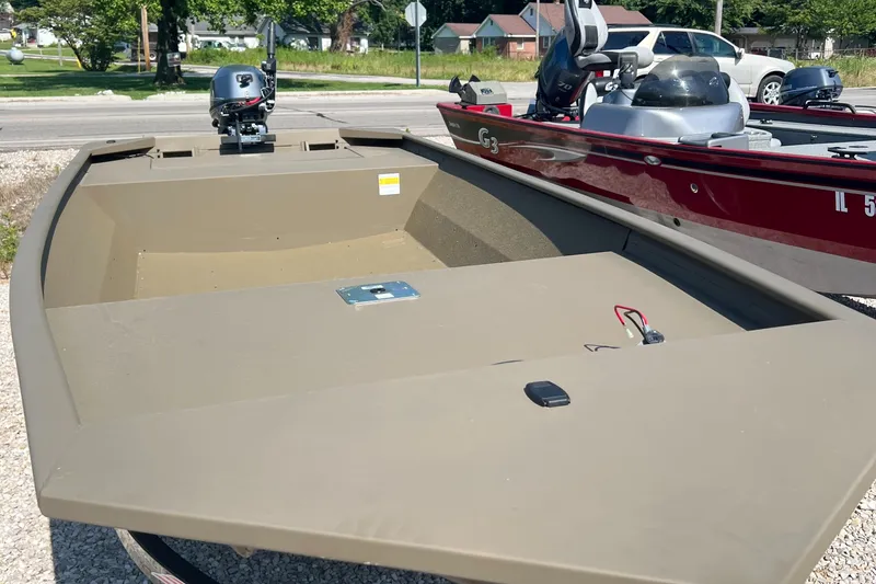 The Image of 2025 G3 1652 VBW boat, olive green, parked on gravel, with outboard motor. - 0