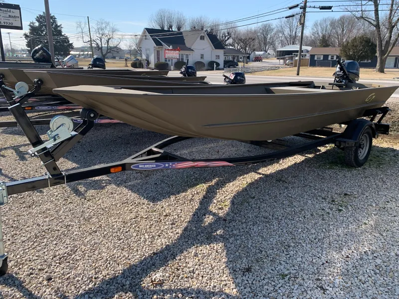 Slide: The Image of 2025 G3 1652 VBW boat on trailer, parked on gravel lot. - 1