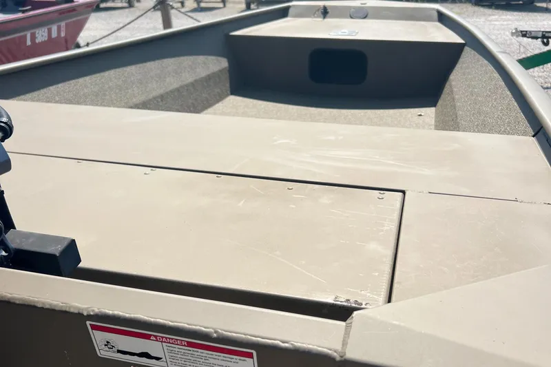 Slide: The Image of 2025 G3 1652 VBW boat interior with storage compartments, beige color, outdoor setting. - 5