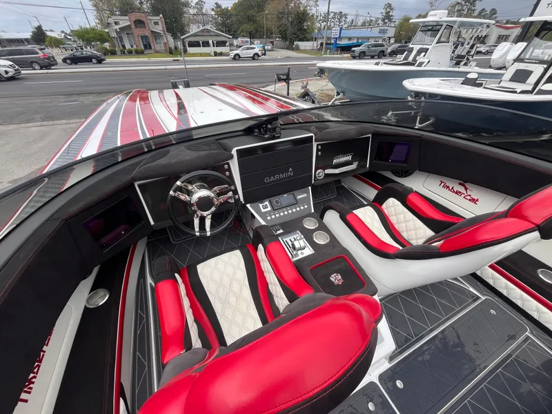 Slide: The Image of Interior of 2020 Wright Performance 360 boat with red and white seating and Garmin navigation system. - 10