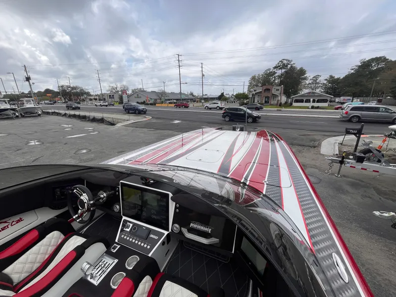 Slide: The Image of 2020 Wright Performance 360 boat with sleek red and white design, parked near a busy road. - 19