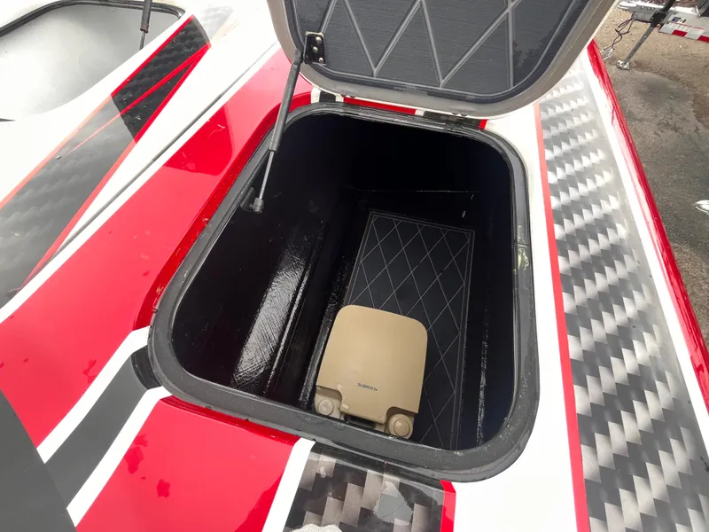 Slide: The Image of Open storage compartment on 2020 Wright Performance 360 boat with red and black design. - 21