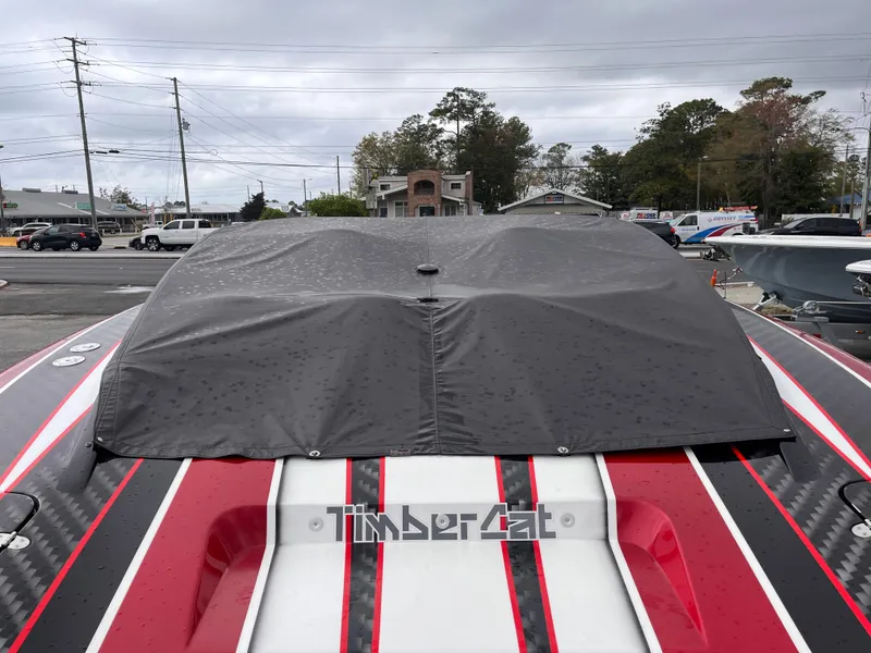 Slide: The Image of 2020 Wright Performance 360 boat with cover, featuring red and white stripes. - 24