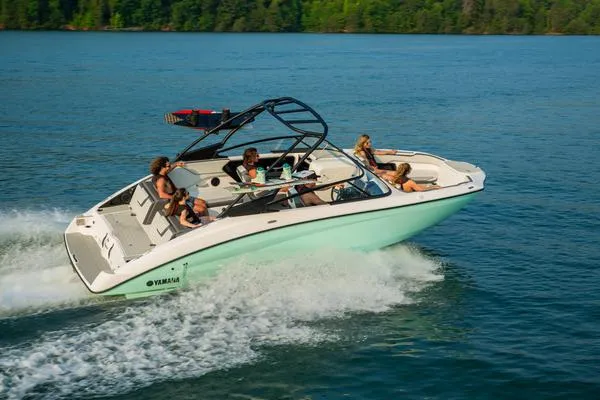 Slide: The Image of 2025 Yamaha AR250 boat cruising on a lake with passengers enjoying the ride. - 11