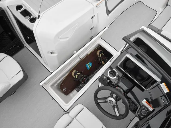 Slide: The Image of 2025 Yamaha Boats AR250 interior with storage compartment and steering wheel. - 7