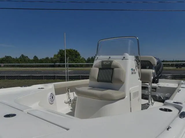 Slide: The Image of 2025 Key West 188 BR boat with seating and console, parked outdoors. - 13