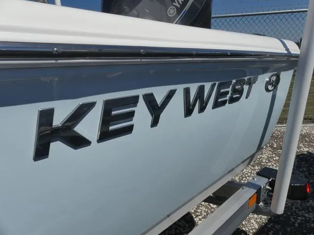 Slide: The Image of 2025 Key West 188 BR boat side view with logo, parked on a trailer. - 15