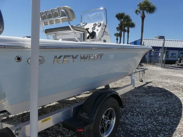 Slide: The Image of 2025 Key West 188 BR boat on trailer, sunny day, palm trees in background. - 4
