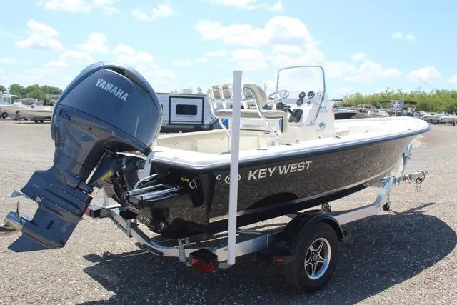 Slide: The Image of 2025 Key West 188 BR boat with Yamaha engine on trailer, parked outdoors. - 4