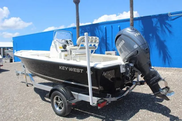 Slide: The Image of 2025 Key West 188 BR boat with Yamaha engine on trailer, parked outdoors. - 6