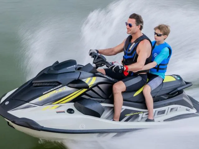 Slide: The Image of Father and son riding 2025 Yamaha Waverunner GP on water, wearing life vests. - 10