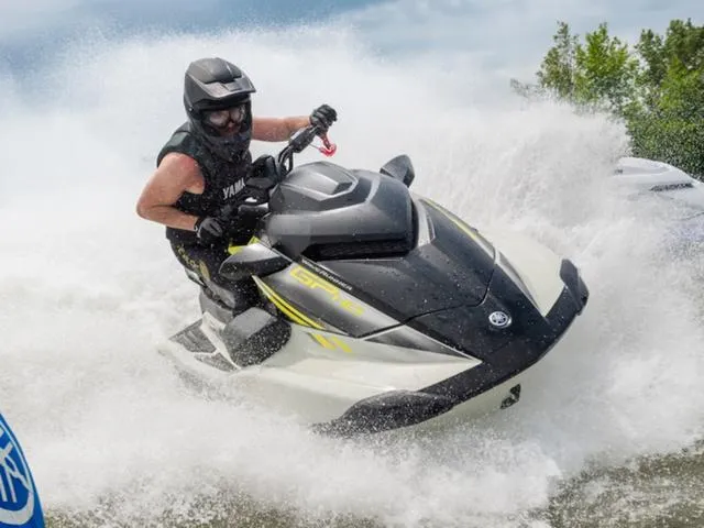 Slide: The Image of 2025 Yamaha Waverunner GP jet ski speeding through water, rider in helmet and vest. - 11