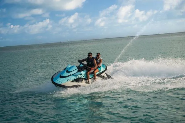 Slide: The Image of 2025 Yamaha Waverunner FX Cruiser HO speeding on open water under a clear sky. - 9