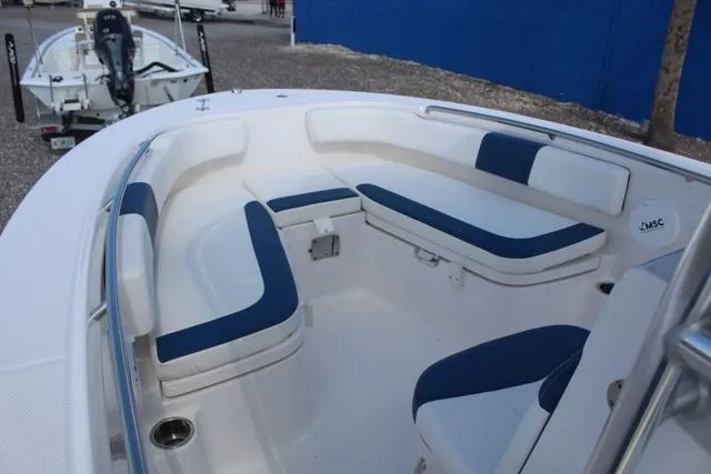 Slide: The Image of 2022 Robalo R200 boat interior with blue and white seating, showcasing spacious design. - 14