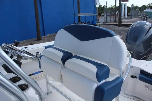 Slide: The Image of 2022 Robalo R200 boat interior with blue and white seating and steering wheel. - 21