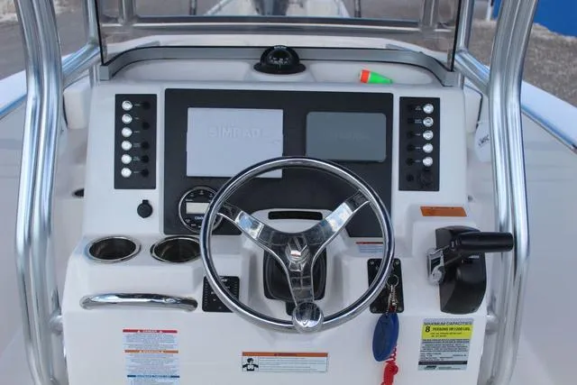 Slide: The Image of 2022 Robalo R200 boat dashboard with steering wheel and control panel. - 22
