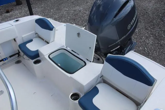 Slide: The Image of 2022 Robalo R200 boat interior with Yamaha engine, featuring seating and storage compartments. - 29