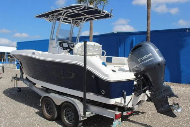 Slide: The Image of 2022 Robalo R200 boat on trailer with Yamaha outboard motor, parked outdoors. - 6